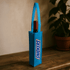 A blue non-woven single wine tote bag with a drink bottle inside and a logo on the side.