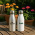 A drink bottle set featuring silver, white, blue, and red aluminium bottles with metal lids and branding areas.