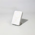 A white wireless charging power bank with a circular charging area and a subtle logo.