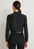 A black long sleeve blouse featuring a button-up design and a pleat detail at the back.