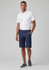 Men's comfort waist cargo shorts in navy, paired with a white short-sleeve shirt and grey shoes. Logo present.