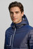 A navy blue unisex patrol jacket featuring a hood and a zippered pocket, designed with a soft shell material.