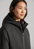 A unisex black sphere jacket with a hood, featuring a zip and a branded logo.