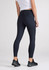 A pair of women's 7/8 length leggings in navy blue with a high waistband, featuring a logo.