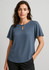 A women's short sleeve blouse in a soft blue, featuring a keyhole detail at the neckline and a relaxed fit.