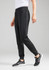 A pair of black track pants with a tapered fit, featuring convenient side pockets and an elastic waistband.