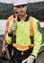 A men's hi-vis long sleeve polo in bright yellow and navy, featuring safety harness and gloves, with a logo.