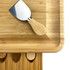 A bamboo cheeseboard with a stainless steel knife and rounded edges, featuring cut-outs for additional utensils.