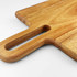 A wooden cheeseboard with a handle, showcasing a smooth finish and natural grain patterns.