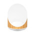 A wireless speaker and charger with a bamboo base and a sleek white top, featuring a minimalistic design.