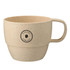 A beige reusable coffee cup made from wheat straw, featuring a logo on the side.