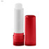 A lip balm stick with a white balm and a bright red casing. The packaging has a clear cap and a twist base.