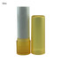 A yellow lip balm stick with a removable cap, standing upright beside its sealed tube.