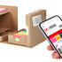 A desk organiser featuring a brown cardboard design holds an array of colourful sticky notes and has a smartphone nearby.