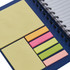 A dark blue notebook with spiral binding, featuring assorted sticky notes in yellow, pink, green, and orange.