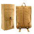 A kraft paper laptop backpack in tan with adjustable straps and a zippered front pocket, featuring branding.