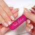 A pink nail file is being used on well-manicured nails with a French tip design. The file features a logo.