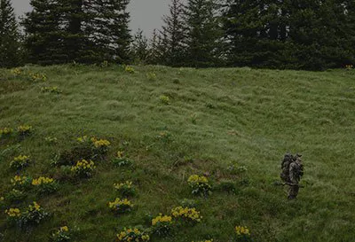 Man in lush green mountian landscape