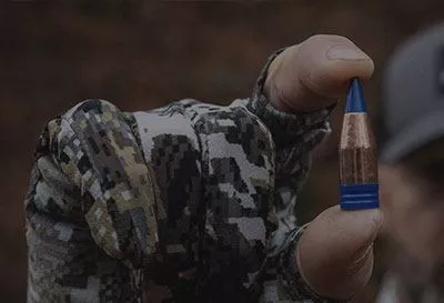 Close up of man holding bullet.