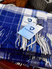 Penn State Lambswool Shawl by Patrick King Woolens, blue and white tartan pattern with fringe trim.