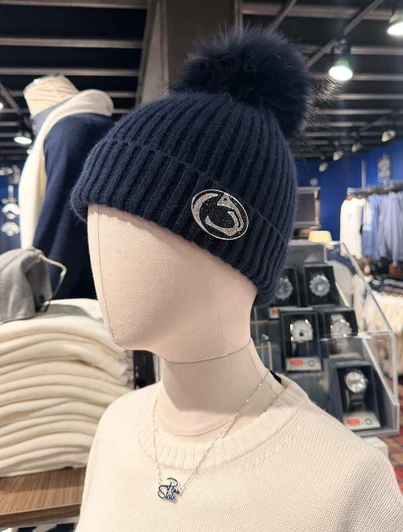 Navy Pom Hat by Linda Richards, a dark blue ribbed beanie with silver logo and pom.