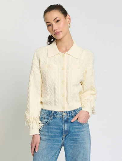 Central Park West Phoebe Cable Fringe Sweater in cream color with button front and fringed details.