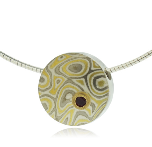 Mokume gane small discus pendant in  22k gold, 18k white gold and silver with ruby set in 22k gold