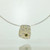 Small Fower Neukit pendant in 22k gold, 18k white gold and silver mokume gane with green diamond in low 22k gold setting