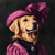 golden retriever with a pink, ornate hat featuring a large, ruffled layered desi