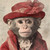 Gentelman Monkey with a large, ornate red top hat and a matching red, lacy garme