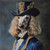 Poodle with a blue and gold themed outfit, including a formal top hat with intr