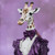 Lady Giraffe in aornate outfit made of layers of fabric in shades of purple, wit