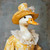 Lady duck in a yellow top hat featuring a decorative floral design Poster Canva