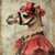 Lady Camel with a red, ornate hat featuring a lace-like design and delicate flo