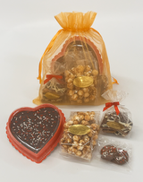 A gift bag filled with treats for your Valentine:
a 4 oz. Bag of The Dangerous Stuff, a 4 oz. Bag of Toffee Popcorn, an 8 oz. Chocolate Fudge Heart, and a 2-pack of Chocolate-covered Oreos