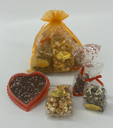 A gift bag filled with treats for your Valentine:
an 8 oz. Bag of The Dangerous Stuff, a 4 oz. Bag of Toffee Popcorn, an 8 oz. Chocolate Fudge Heart, and a 5-pack of Chocolate-covered Oreos.
