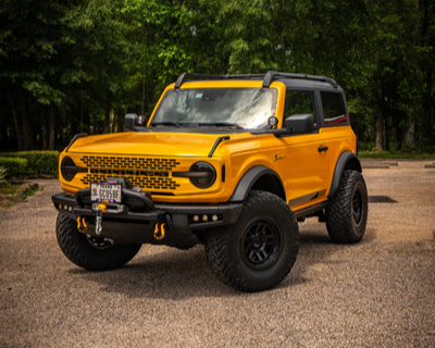 Yellow Ford Bronco with aftermarket offroad parts