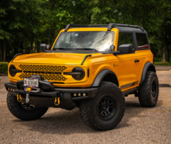 Yellow Ford Bronco with aftermarket off-road modifications