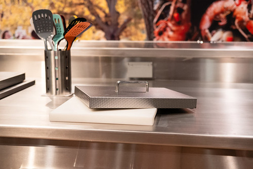 Hestan Outdoor Countertop Trash Chute | Commercial-grade cutting board serves double duty, sliding over for easy access to trash chute.
 Hestan Outdoor Countertop Trash Chute | Commercial-grade cutting board serves double duty, sliding over for easy access to trash chute.