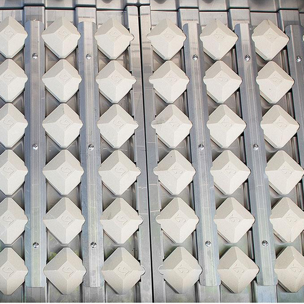 Alfresco Grills 36" Sear Zone Gas Grill on Cart | High-density composite material in a flat top pyramid-shape, with a heat-holding cavity underneath, delivers intense heat to the cooking surface. Radiant tray locks briquettes in place.