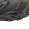 Mini XRX Plus & Mini XRX-R Plus Left Front Wheel & Tire Assembly 145/70-6, close-up view of the black tire’s deep tread pattern and rubber surface.