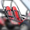 Trailmaster 150 XRS and 150 XRX bucket style seat back, showing two sporty red and black bucket seats with side harness slots and detailed stitching.
