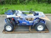 TrailMaster Mid XRX-R Go Kart for Kids, assembled blue off-road electric go-kart with 5-point harness, reverse, electric start, and protective packaging.