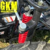 TrailMaster Mid XRX-R Go Kart For Kids with Reverse, Electric Start, 5 Point Harness, assembled showing suspension system with red coil shock absorber and part of the wheel