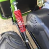 TrailMaster Mini XRX/R+ Go Kart with Reverse, assembled front suspension and wheel, showing suspension coil spring and part of the wheel.