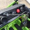 Assembled TrailMaster Mini XRX/R+ Go Kart with Reverse for Ages 4+, close-up of the go kart's dashboard featuring ignition switch, red hazard button, and steering wheel.