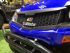 Trailmaster Taurus 200U, close-up of the front of the utility UTV with a black honeycomb grille, blue body, and chrome bumper.