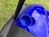 Trailmaster Taurus 200U utility SXS UTV, blue vehicle console with cup holder on green grassy background.