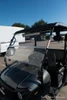 Trailmaster Taurus 200U Utility SXS UTV, front view of the black utility vehicle with a clear windshield and roof, parked outdoors under a clear blue sky.