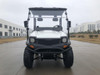 Trailmaster Taurus 200U utility SXS UTV, front view of a white off-road vehicle with rugged tires, protective bumper, and clear windshields on a paved outdoor setting.